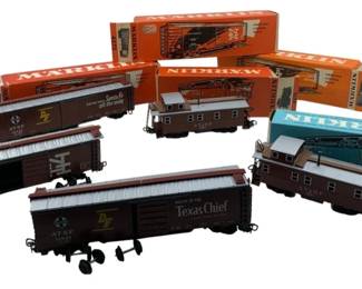 249 - Group Lot of 5 Marklin Train Cars 2"x2"x8" (Description): Several cars feature Santa Fe and ATSF railroad markings, including one marked "Route of the Texas Chief." Cars come with original Marklin boxes. Each car measures approximately 2 inches by 2 inches by 8 inches.