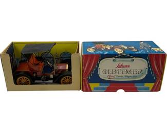 1183 - Schuco Old Timer 1909 Dakota in Box (Description): Schuco Oldtimer 1909 Opel Doktor Wagen model car in original box. This vintage tin toy depicts a classic early automobile with a folding canopy top, detailed red body, and yellow spoked wheels. The model comes in its original colorful display box featuring theatrical curtain graphics and period illustrations. A collectible piece from Schuco's celebrated Oldtimer series.