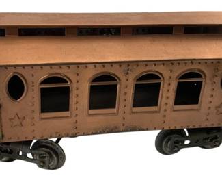 225 - Vintage Lionel Copper Finish Passenger Car (Description): Featuring detailed metalwork with riveted panels, arched and round windows, open observation platforms at both ends with railings and steps, and star decorations on the sides. Mounted on metal wheels. Measures 5" x 4" x 14".