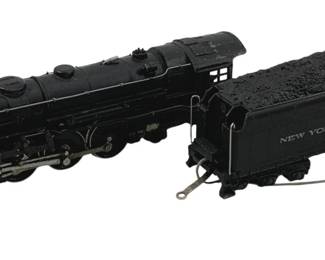 912 - Lionel #5342 Locomotive w/ Coal Car HO Scale (Description): Lionel #5342 locomotive with New York Central coal tender car in HO scale. The black steam locomotive features detailed running gear and cab, accompanied by a matching black coal car loaded with simulated coal. Measures 2.5" x 9" x 1.5".