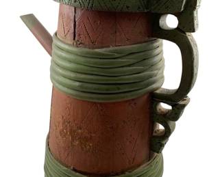 64 - 19th C. Scandinavian Staved Wooden Tankard (Description): A 19th century Scandinavian staved wooden tankard featuring traditional construction with vertical wooden staves bound by green-painted wooden bands at the top and bottom. The body displays carved geometric patterns and diamond motifs in a reddish-brown finish. The hinged lid is ornately carved with decorative scrollwork and topped with a turned finial. A curved handle with scrolled thumb rest is attached