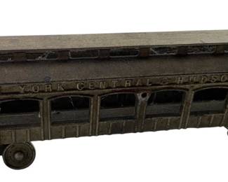 180 - Ant. Cast Iron NY Central & Hudson River Toy (Description): Antique cast iron toy train car marked "New York Central & Hudson River" along the upper side. This vintage passenger car features detailed window cutouts, a curved roof with clerestory windows, and platform ends on both sides. The piece displays a dark patina consistent with its age, mounted on small wheels. Measures 4" x 13" x 3".