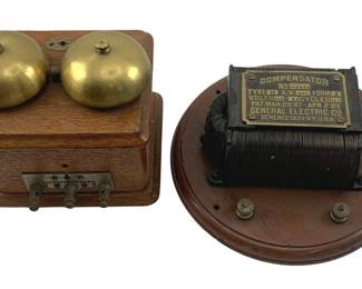 900 - 2pc. Lot Ant. Telephone Ringer & Compensator (Description): A two-piece lot featuring antique electrical components. The first piece is a wooden wall-mounted telephone ringer box with dual brass bells and terminal connections at the base. The second piece is a General Electric Compensator mounted on a circular wooden base, featuring a wire-wound coil transformer with a brass identification plate indicating patent dates of March 29, 1887 and April 2, 1889, manufactured in Schenectady, N.Y.,