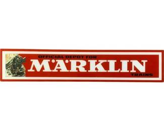 1190 - Marklin Plastic Train Sign 6.5"x32.5" (Description): Marklin plastic train sign measuring 6.5" x 32.5". This red and white advertising sign reads "Official Depot for Marklin Trains" and features the classic Marklin logo along with an image of a steam locomotive. The elongated rectangular format andld lettering make this an attractive piece of model railroad memorabilia suitable for display in a train room or collector's space.