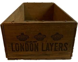 1165 - London Layers Wood Crate 28"x6"x10" (Description): Vintage London Layers wooden crate featuring decorative crown motifs and "20 LBS. NET" marking. This rustic shipping crate displays the London Layers branding prominently on the front panel with three crown emblems. The crate shows authentic age a patina consistent with antique wooden shipping containers. Measures 28" x 6" x 10".