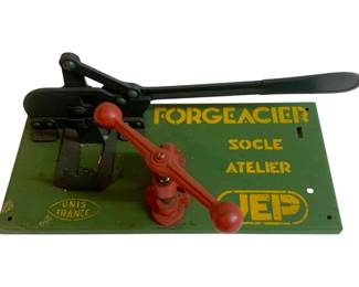 1076 - Forgeacier French Tool 12"x6"x5" (Description): Forgeacier French tool by JEP, marked "Unis France" and "Socle Atelier." This vintage metalworking press features a lever-operated mechanism mounted on a painted metal base. Measures 12 inches by 6 inches by 5 inches.