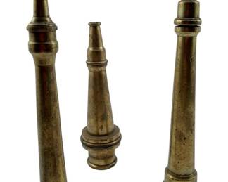 86 - 3 Vtg Brass Firehose Nozzles One Signed (Description): Three vintage brass firehose nozzles, one of which is signed. These solid brass nozzles feature traditional tapered designs with knurled adjustment bands and weighted bases. The patina shows authentic age and use. The largest nozzle measures 8 inches in height.