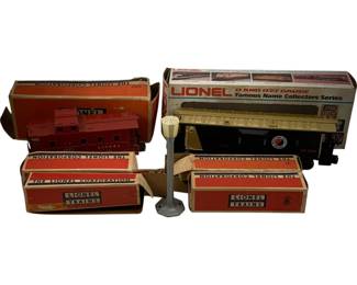 1104 - Lot Lionel Train Cars & Accessories w/ Boxes (Description): A lot of Lionel train diecuts including multiple O and O27 gauge train cars with original boxes. The collection features a red caboose, a Northern Pacific stock car from the Famous Name Collectors Series, and additional boxed items. A street lamp accessory is also included. Several pieces retain their original Lionel Corporation packaging.