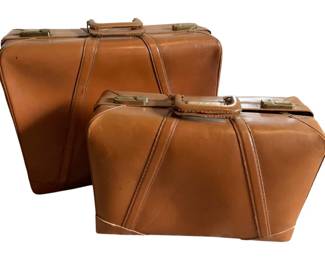 156 - Pr Vintage Brown Leather Luggage Bags (Description): Set of two vintage leather luggage bags in a warm cognac brown color. Features brass hardware and classic stitched detailing throughout. The matching set includes one larger and one smaller suitcase, each with a sturdy top handle. Measurements: 18"x 24" x 8".
