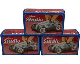1210 - 3pc Schuco Studio Race Cars in Boxes (Description): Three Schuco Studio race cars in original boxes. Each box features the Mercedes Grand Prix 1936 design with the number 7 silver racing car depicted on the packaging. The boxes display the German text "Für den kleinen Rennwagen-Monteur" (For the lile racing car mechanic). All three sets appear complete in their original blue and red illustrated boxes.