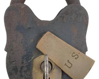 608 - US Marked Padlock w/Key 4"x2.5" (Description): Antique US marked padlock with key. The lock features a heart-shaped iron body with brass keyhole cover stamped "U.S." Measures 4 inches by 2.5 inches.