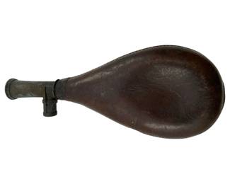 721 - Antique Gunpowder Flask Brass & Leather (Description): Antique gunpowder flask crafted from brass and leather. This powder flask features the traditional teardrop shape with a brass dispensing mechanism at the neck. Measures 1 inch by 8 inches by 3.5 inches.