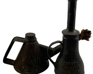 1081 - 2pc Antique Railroad Oilers 10" (Description): Two antique railroad oilers measuring 10 inches. The lot includes a conical-shaped oiler marked Southern Railway with a rectangular handle and threaded cap, and a bottle-shaped cast iron oiler marked "Dayton Malleable Iron Co." featuring a long spot with wick and side handle. Both pieces display a dark patina consistent with their age and industrial use.