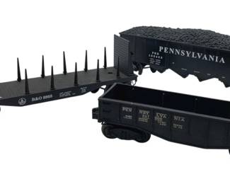 337 - Group Lot of 3 Pennsylvania Train Carts (Description): Group lot of three Pennsylvania train carts including a B&O flatcar with stake posts, a Pennsylvania hopper car with coal load, and a Pennsylvania gondola car. Each cart measures approximately 3 inches by 10 inches by 2 inches.