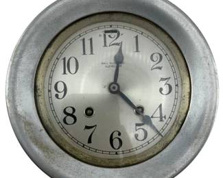 728 - Chelsea Clock Co. USA Metal Clock 3.5"x6" (Description): Chelsea Clock Co. USA metal clock. This American-made timepiece features a metal case with a classic round dial displaying Arabic numerals. Measures 3 1/2 inches by 6 inches. Used as is electric/electronic/mechanical item. No guarantee all components, untested.