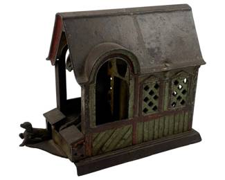 943 - Antique Metal Mechanical Bank #5 Damaged (Description): Antique metal mechanical bank, designated as #5 in the collection. This bank features a figural design with architectural elements. The piece shows damage and wear consistent with age. Measures 3.5 inches by 5 inches by 6 inches.