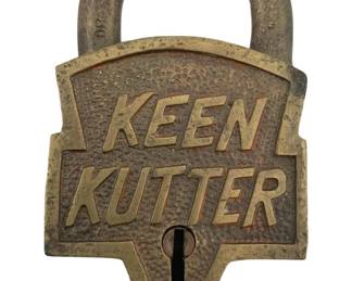 648 - E.C. Simmons Keen Kutter Padlock w/o Key (Description): E.C. Simmons Keen Kutter padlock without key. This vintage brass padlock features the distinctive Keen Kutter branding with raised lettering and the E.C. Simmons maker's mark on the shackle. Measures 3 1/4" x 2".