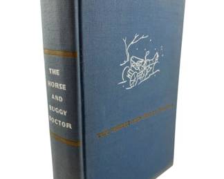 141 - 1938 The Horse & Buggy Doctor by Hertzler (Description): A 1938 hardcover edition of "The Horse and Buggy Doctor" by Arthur E. Hertzler. The book features a blue cloth binding with gold lettering on the spine and a white illustrated vignette of a horse and buggy scene on the front cover.