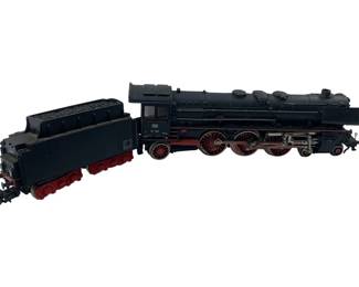 311 - Marklin Locomotive with Coal Car 2"x2"x11" (Description): Marklin model locomotive with accompanying coal car. This HO scale steam engine features classic black bodywork with contrasting red wheels and trim, detailed cab windows, and a coal-filled tender. The locomotive displays the traditional German railway design with multiple drive wheels and authentic detailing. Measures 2 inches by 2 inches by 11 inches overall.