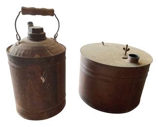 393 - 2 Vintage Metal Gas/Oil Cans 11" (Description): Two vintage metal gas/oil cans featuring rustic patina. One can has a bail handle with wooden grip and screw cap, while the other is a lower cylindrical form with lid. Taller can measures 11 inches.