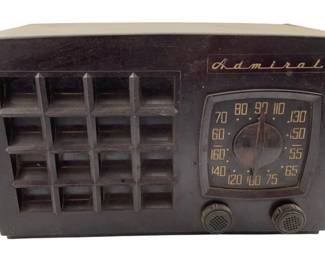 790 - Admiral Radio 6.5"x10.5"x5.5" (Description): Admiral radio in a brown Bakelite case featuring a grid-pattern speaker grille on the left side and a semicircular tuning dial on the right. The dial displays both AM and shortwave frequency bands with two control knobs below. Measures 6 1/2" x 10 1/2" x 5.5". Used as is electric/electronic/mechanical item. No guarantee all components, untested.