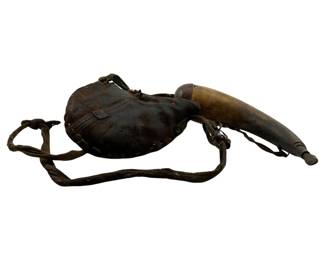 7 - Antique Leather Pouch w/ Powder Horn (Description): Antique leather pouch with powder horn. The well-worn leather pouch features hand-stitched construction with a braided cord strap for carrying. The accompanying powder horn has a wooden plug at the base and tapered spout tip. Shows authentic age and patina consistent with period use. Measures 6" x 7.5" - 10" x 2.5".