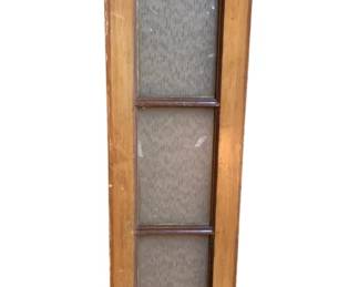 1159 - Antique Wood Window Panel 35"x10" (Description): Antique wood window panel featuring three panes of textured glass set in a warm honey-toned wooden frame. The piece shows authentic age-related patina and wear consistent with its vintage character. Measures 35 inches tall by 10 inches wide.