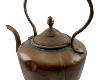 57 - Copper Tea Kettle 12.5"x12"x8" (Description): Antique copper tea kettle with a rounded body, curved spout, and swing handle with cylindrical grip. The lid features a turned acorn-style finial. The piece displays a lovely aged patina with traces of verdigris, indicative of its age and use. Measures 12 1/2" x 12" x 8".