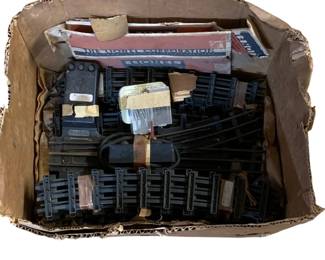 1112 - Box Lot Vintage Lionel Train Tracks & Parts (Description): A box lot of vintage train items including Lionel track pieces, curved and straight sections, along with electrical components and accessories. The lot includes original Lionel Corporation boxes. Various track pieces show age-appropriate wear consistent with vintage use.