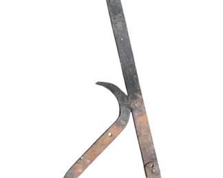 440 - Antique Metal Tool 31"x15" (Description): Antique metal tool featuring a hinged design with curved hooks and flat bars. The piece shows aged patina consistent with its age. Measures 31 inches by 15 inches.