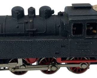 293 - Marklin Black Steam Locomotive Model 2"x2"x6" (Description): Marklin locomotive model train in black with red wheels and red accents. This detailed steam engine features a classic tank locomotive design with visible cab interior, dual smokestacks, and authentic detailing throughout. Measures 2" x 2" x 6".