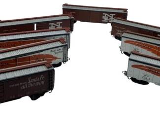 288 - Group Lot of 8 Marklin Train Cars 3"x2"x8" (Description): The collection includes various freight and boxcar models. Each car measures approximately 3" x 2" x 8".
