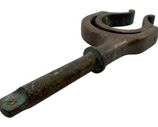 118 - Antique Bronze Oarlock 1"x12.5"x5" (Description): Antique bronze oarlock featuring a U-shaped cradle designed to hold an oar in place during rowing. The piece displays a rich patina consistent with age, showing traces of verdigris typical of aged bronze. The cylindrical shaft extends from the oarlock head, designed to insert into a boat's gunwale. Measures 1" x 12.5" x 5".