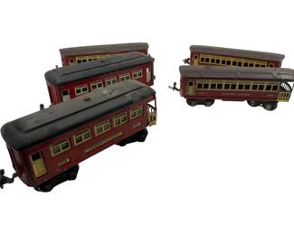 317 - Group Lot of 5 Lionel Passenger Carriers (Description): Group lot of five Lionel passenger carriers in maroon and cream livery with black roofs. The collection includes observation cars and coach cars marked with Lionel Lines branding. Each car features detailed windows and metal construction with coupling hardware. Cars measure 2" x 2" x 9". Shows age-appropriate wear consistent with vintage use.