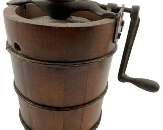 98 - Antique Salesman Sample Ice Cream Freezer (Description): Antique salesman sample ice cream freezer featuring a wooden stave bucket construction with metal banding and a cast iron hand-crank mechanism with domed lid. This miniature demonstration piece showcases the traditional barrel-style design typical of early ice cream makers. Measures 7" x 8" x 5".