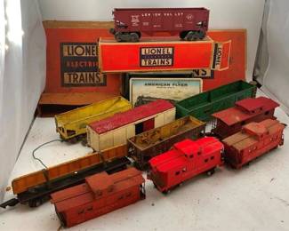 525 - Lot O Scale Trains (Description): A lot of O scale trains including various freight cars and cabooses. The collection features pieces from multiple manufacturers including Lionel and American Flyer, with some original boxes present.