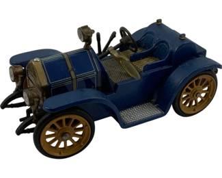 1213 - Schuco Wind-Up Car 2"x4"x2" (Description): Schuco wind-up car in blue with gold-tone spoke wheels and brass-colored accents. This vintage-style diecast model features an open touring car design with detailed engine, headlamps, steering wheel, and running boards. Measures 2 inches high by 4 inches long by 2 inches wide.