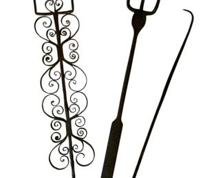48 - 3 Hand Forged Wrought Iron Fireplace Tools (Description): Group lot of three hand forged wrought iron fireplace tools. The collection includes a decorative toasting fork with elaborate scrollwork design, a three-pronged fork with flat handle and ring loop, and a simple hooked poker with ring loop. Each piece measures approximately 22 inches in length and displays the characteristic dark patina of antique wrought iron craftsmanship.