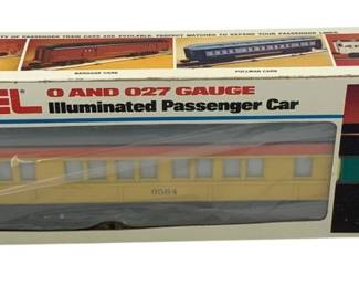 854 - Lionel O and O27 Gauge Passenger Car in Box (Description): Lionel Special Passenger Car in O Scale, presented in original box. This illuminated passenger car is designed for O and O27 gauge layouts. The car features a cream and red color scheme with the number 9584 displayed on the side. The original packaging depicts various passenger train car options available in the Lionel line. Suitable for ages 8 to adult.