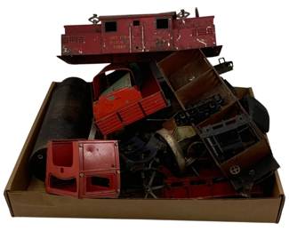 1231 - Tray Lot Antique Toys (Description): Tray lot of antique toys including various metal toy train cars and vehicle parts. The collection features a red painted tin caboose marked 'The Ives Railway Lines' along with assorted pressed steel and tin toy components in various states of wear. Pieces display vintage patina consistent with age and use.