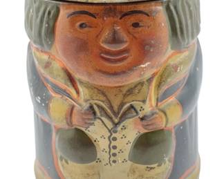 101 - 1911 Huntley & Palmers Toby Jug Biscuits Tin (Description): A 1911 Huntley & Palmers biscuits tin designed in the form of a Toby Jug. The lithographed tin features a cheerful rotund gentleman figure wearing a tricorn hat, traditional vest with buttons, and period attire in cream, orange, and dark gray tones. The tin shows charming aged patina consistent with its age. Measures 6.25" x 5" x 6".