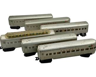 996 - 6pc Set Marx Santa Fe Metal Train Cars (Description): A six-piece set of Marx Santa Fe metal train cars. The collection includes various passenger car styles in silver finish with Santa Fe livery markings. Each car measures 3.5 inches wide by 11 inches long by 2 inches tall.