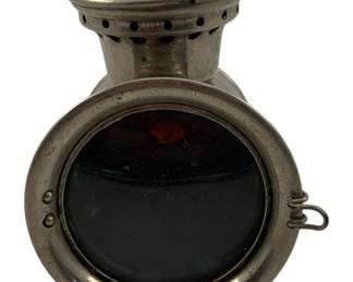 1084 - Old Sol Signal Light 6"x4"x8" (Description): Old Sol Light in nickel-plated metal construction. Features a lantern-style design with a circular glass front panel, ventilation holes around the chimney and base, and a hinged side clasp. Measures 6" x 4" x 8". Used as is electric/electronic/mechanical item. No guarantee all components, untested.