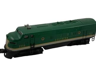 928 - Lionel Southern Locomotive #2356 3.5"x12"x3" (Description): Lionel Southern locomotive #2356 in green with gold and cream striping. This O-gauge diesel locomotive features the classic F3 body style with "Southern" lettering on the side and "Built by Lionel" marking. The engine displays the distinctive streamlined design characteristic of mid-century Lionel trains. Measures 3.5" x 12" x 3".