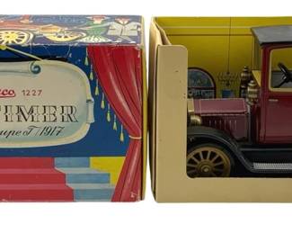 838 - Schuco 1227 1917 Ford Coupe T w/ Key & Box (Description): Schuco Oldtimer 1917 Ford Coupe T model car with original wind-up key and original box. The model number is 1227. The vintage tin toy features a red body with black fenders and top, detailed spoke wheels, and comes in its original theatrical-style display packaging depicting a stage curtain design.