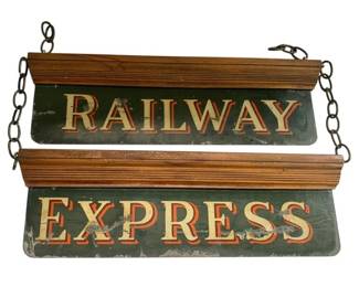 823 - Hanging Railway Express Porcelain Metal Signs (Description): Railway Express porcelain metal signs with wooden holder and hanging chains. The double-sided signs feature cream and red lettering on a dark green background, reading "Railway" and "Express" vertically. The signs are mounted in a wood frame designed for hanging display. Signs measure 22 inches by 8 inches.