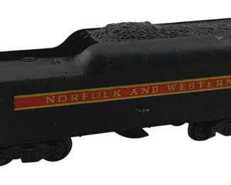 877 - Lionel Norfolk & Western Coal Car O Scale (Description): Lionel Norfolk and Western coal tender in O scale. This black die-cast tender features the distinctive Norfolk and Western livery with a red banner and gold lettering on the side, marked 746W. The tender is loaded with simulated coal and includes standard O gauge couplers. Measures 3.5 inches high by 9 inches long by 2.5 inches wide.