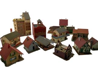 326 - Faller Display Houses Group Lot 7" (Description): A collection of Faller display houses, ideal for model railroad layouts or dioramas. This group lot includes various European-style buildings such as residential homes, a tall department store (marked "Kaufhaus"), half-timbered cottages, and industrial structures. The buildings feature detailed construction with painted facades, tile roofs in various colors, and architectural details typical of German village and town settings.