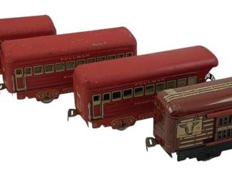 887 - 4pc. Lot Marx Tin Litho Train Cars 3"x6"x1.5" (Description): A lot of four Marx tin lithograph train cars measuring 3" x 6" x 1.5". The set includes three red Pullman passenger cars with green and cream window detailing, and one brown Union Pacific cattle car with decorative lithographed cattle imagery. All cars feature black wheel assemblies and coupling hooks for connecting to other train cars. The cars show vintage wear consistent with age and play use.