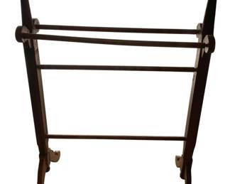 390 - Wooden Quilt Rack 36"x27"x13" (Description): Wooden quilt rack featuring a traditional design with multiple horizontal bars for displaying quilts or blankets. The piece stands on curved feet and measures 36 inches tall by 27 inches wide by 13 inches deep.